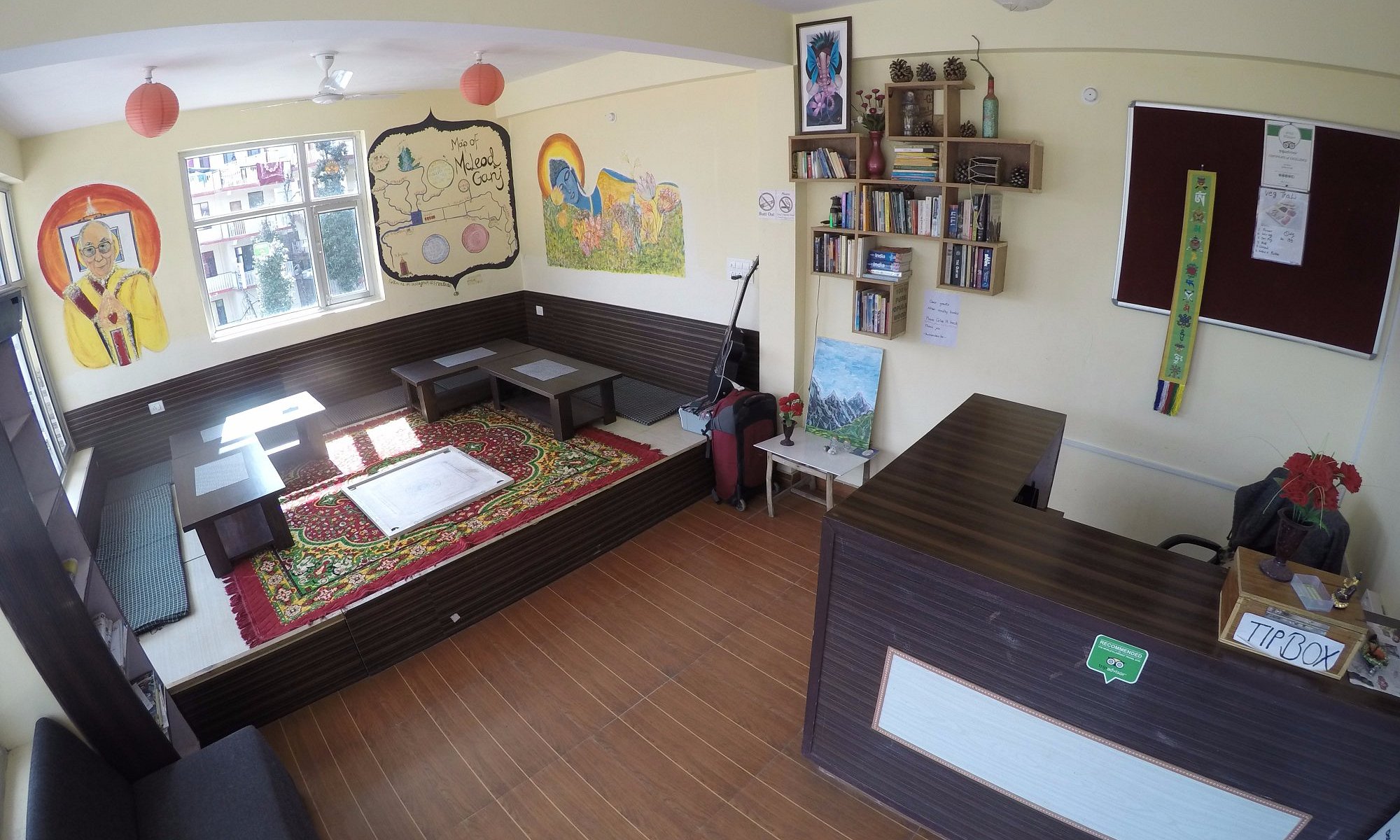 The hand-painted Backpackers Inn signboard with distance arrows to Tokyo, Seoul, New York, Paris, London